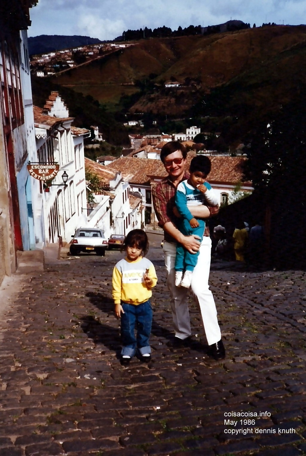 Dennis Knuth carrying Dudu up the hill with Thacila walking