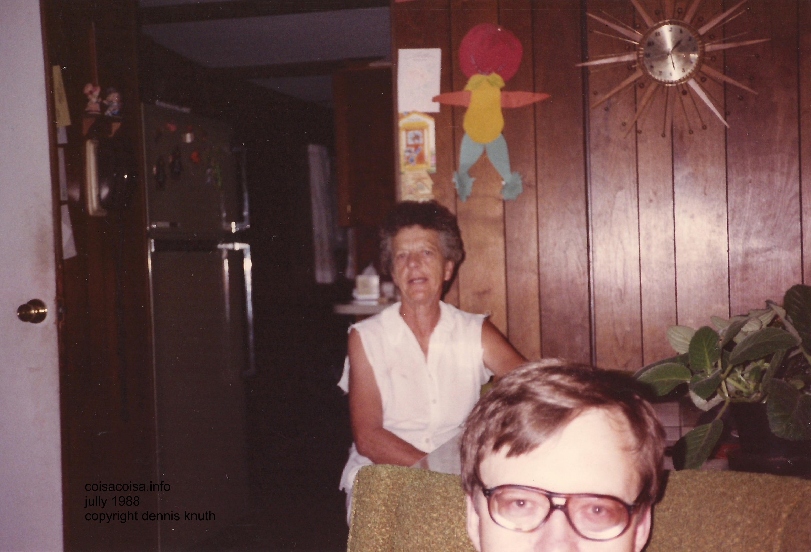 Emogene talking and Dennis peeping in the photo frame