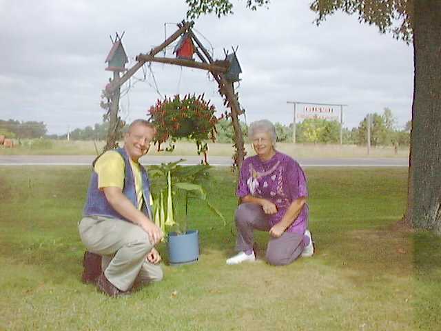 Ardith showing off her plants to  Dennis
