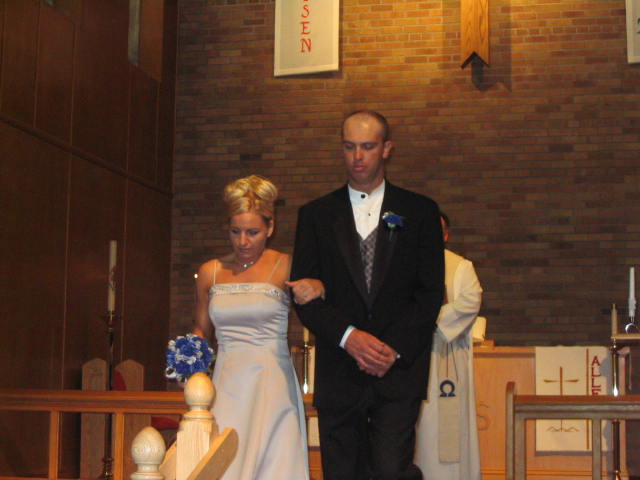 Brides maid and groomsman exit the wedding