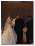 Grooms man with the bride and groom at the altar