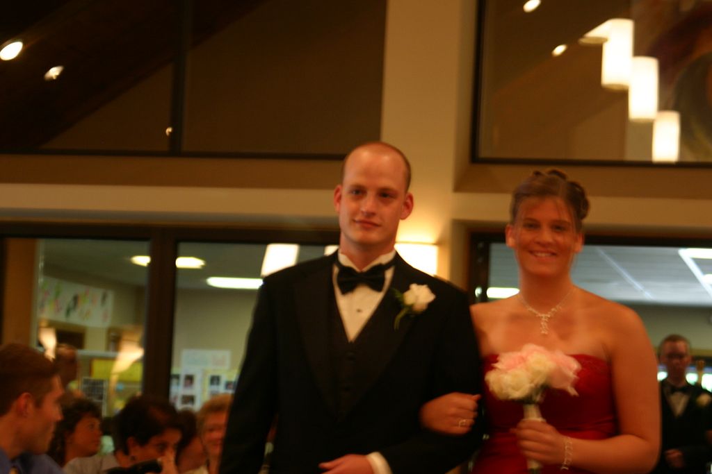 Nathan Moore walks with a bridesmade