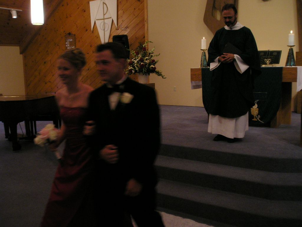Bridesmaid and Mike exit the church