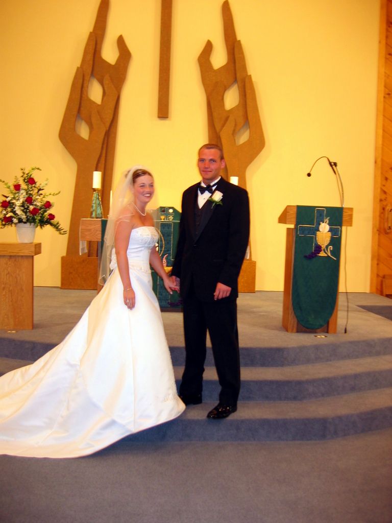 Julia and Justin holding hands at the chruch altar