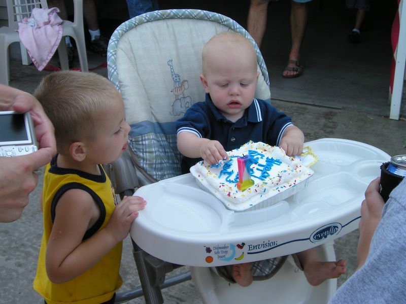 Cousin watches Jared with his cake