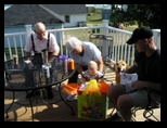 Great Grandparents watch 1 year old Jared open his gifts.