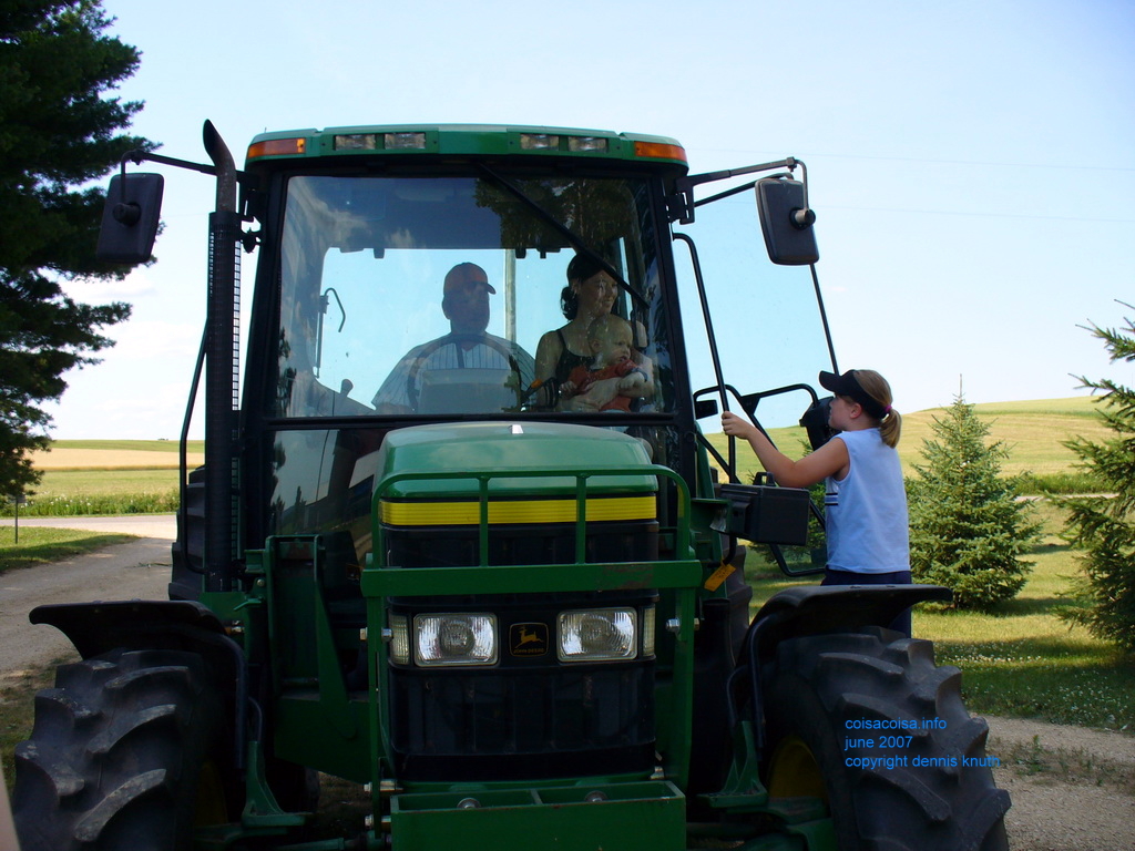 Kelsey climbs into the tractor