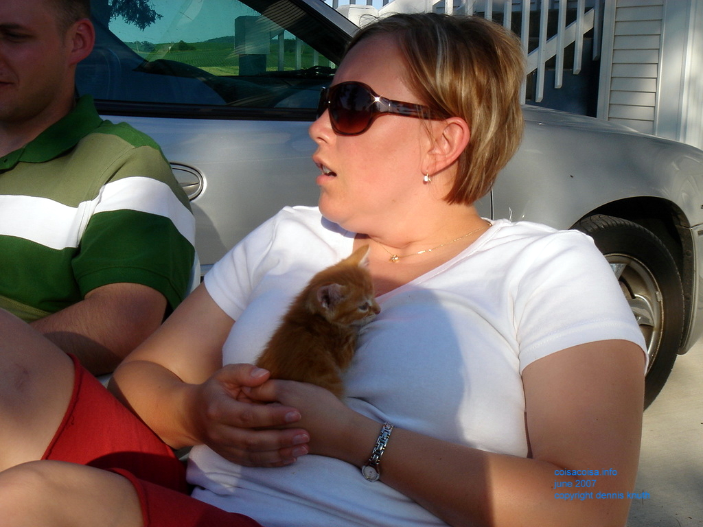 Kelli cuddling a kitten on the farm