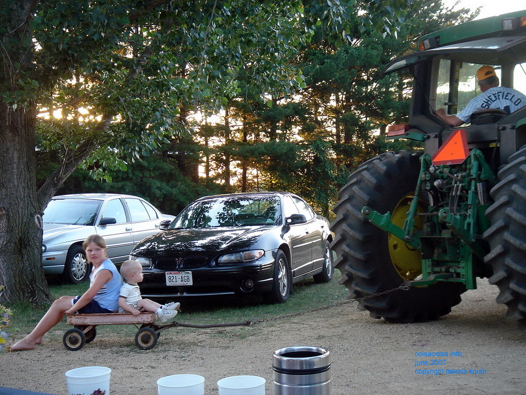 Kelsey and Jared get pullled by a John Deere tractor