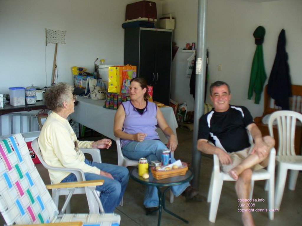 Helton Kelly and Emogene drink beer in the garage