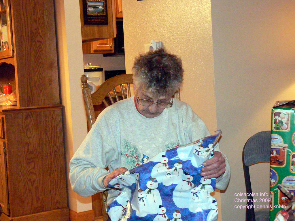 Emogene opens her Xmas gift wrapped in snowman paper