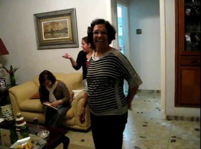 Vincentina on her porch with family