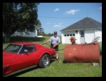 Gary fills up the gas of the red Corvette