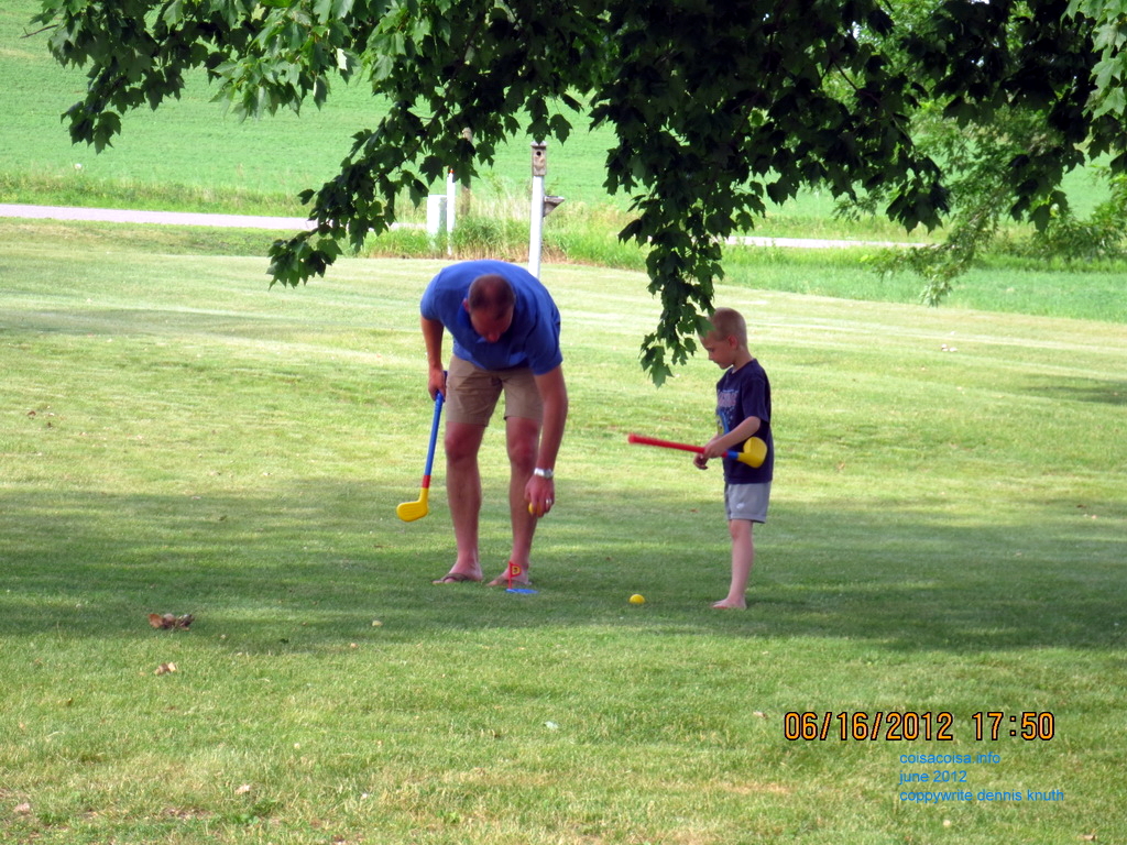 Justin tees up a plastic golf ball for Jared
