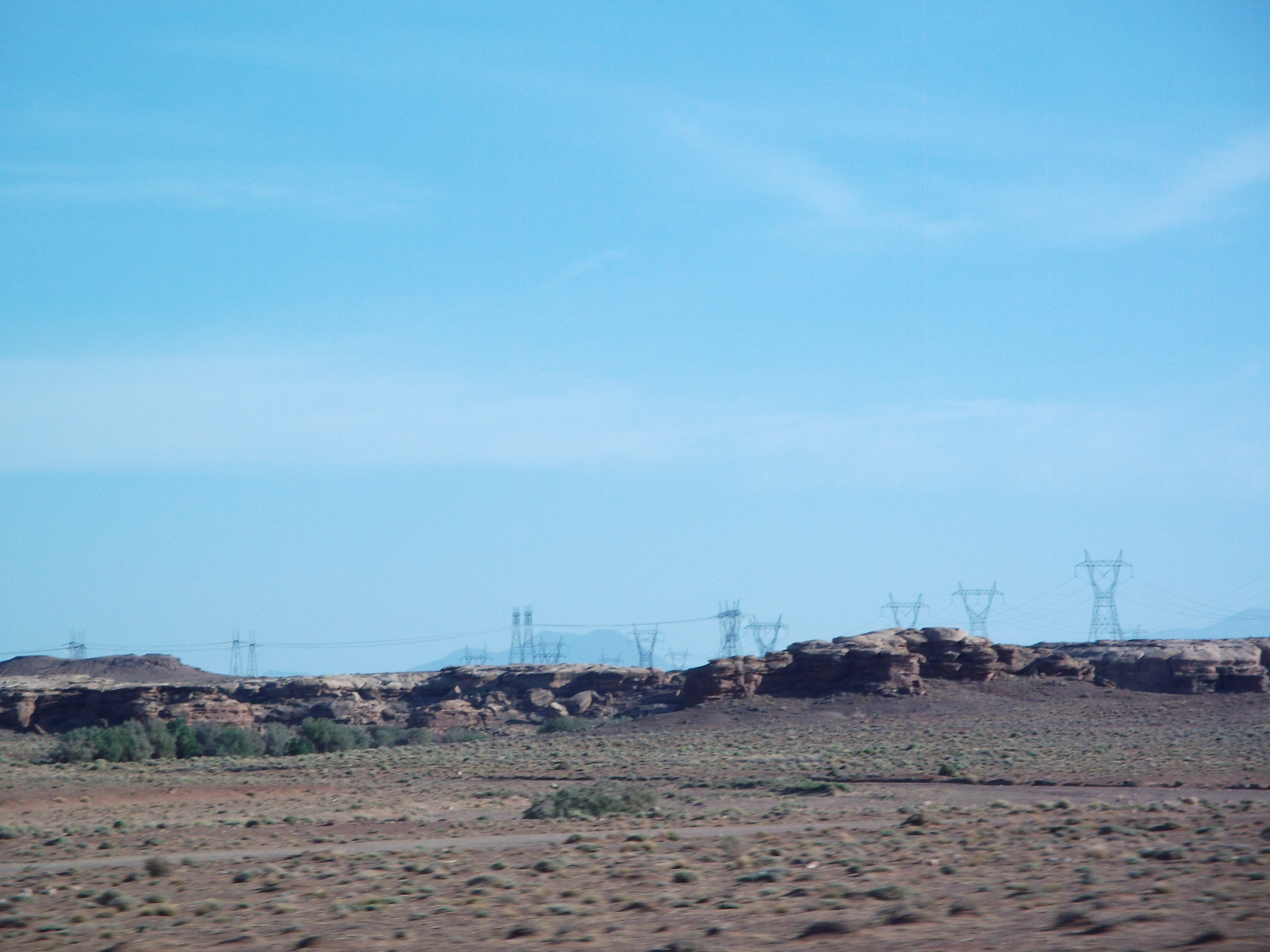 Massive power lines transverse the outer edges of the Painted Desert