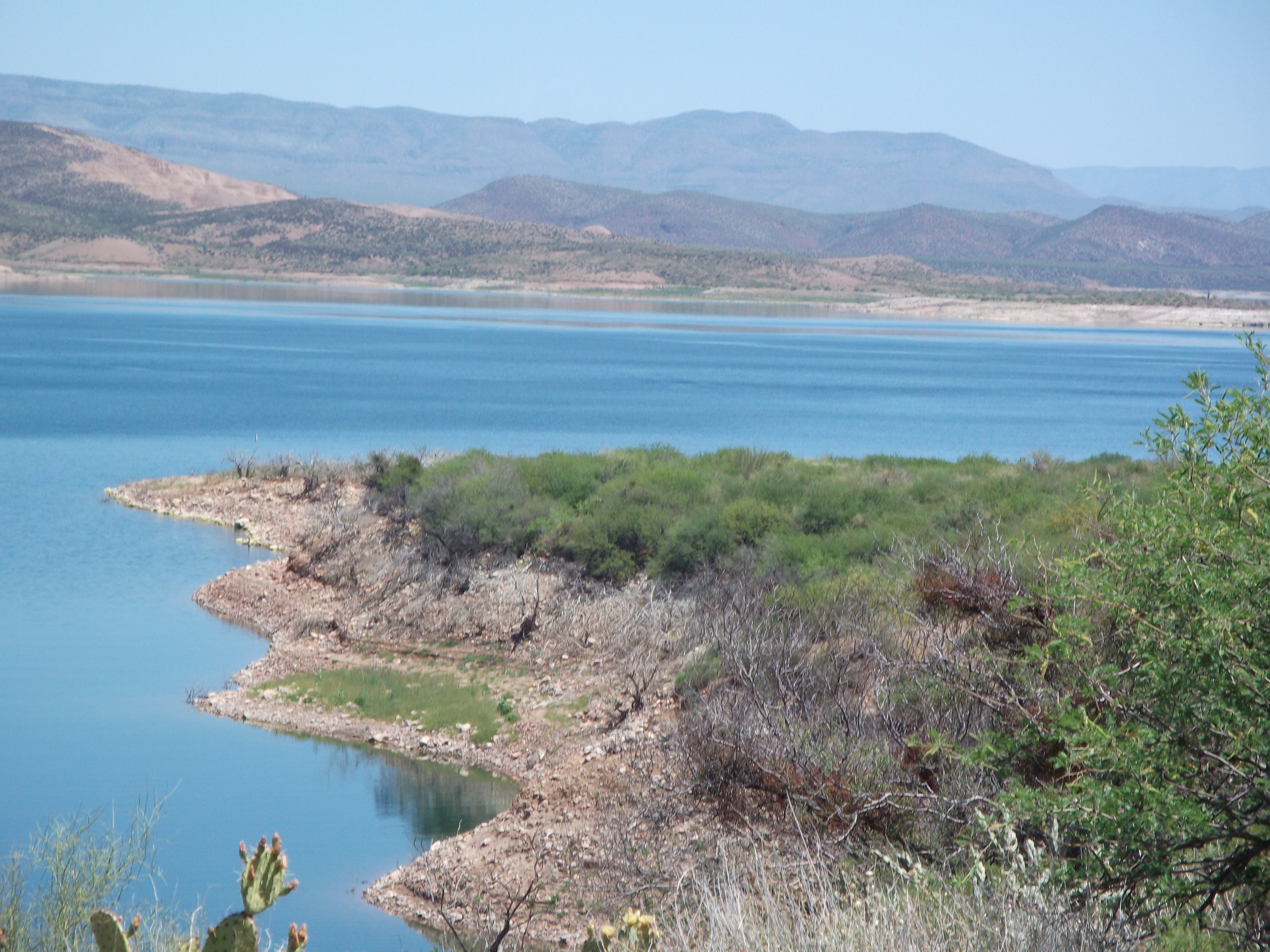 Blue Roosevelt Lake under desert skys