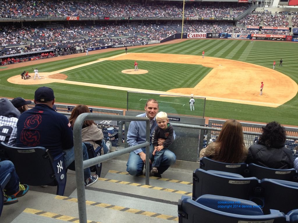 Colin and Father Justin with the Yankee baseball field in the background