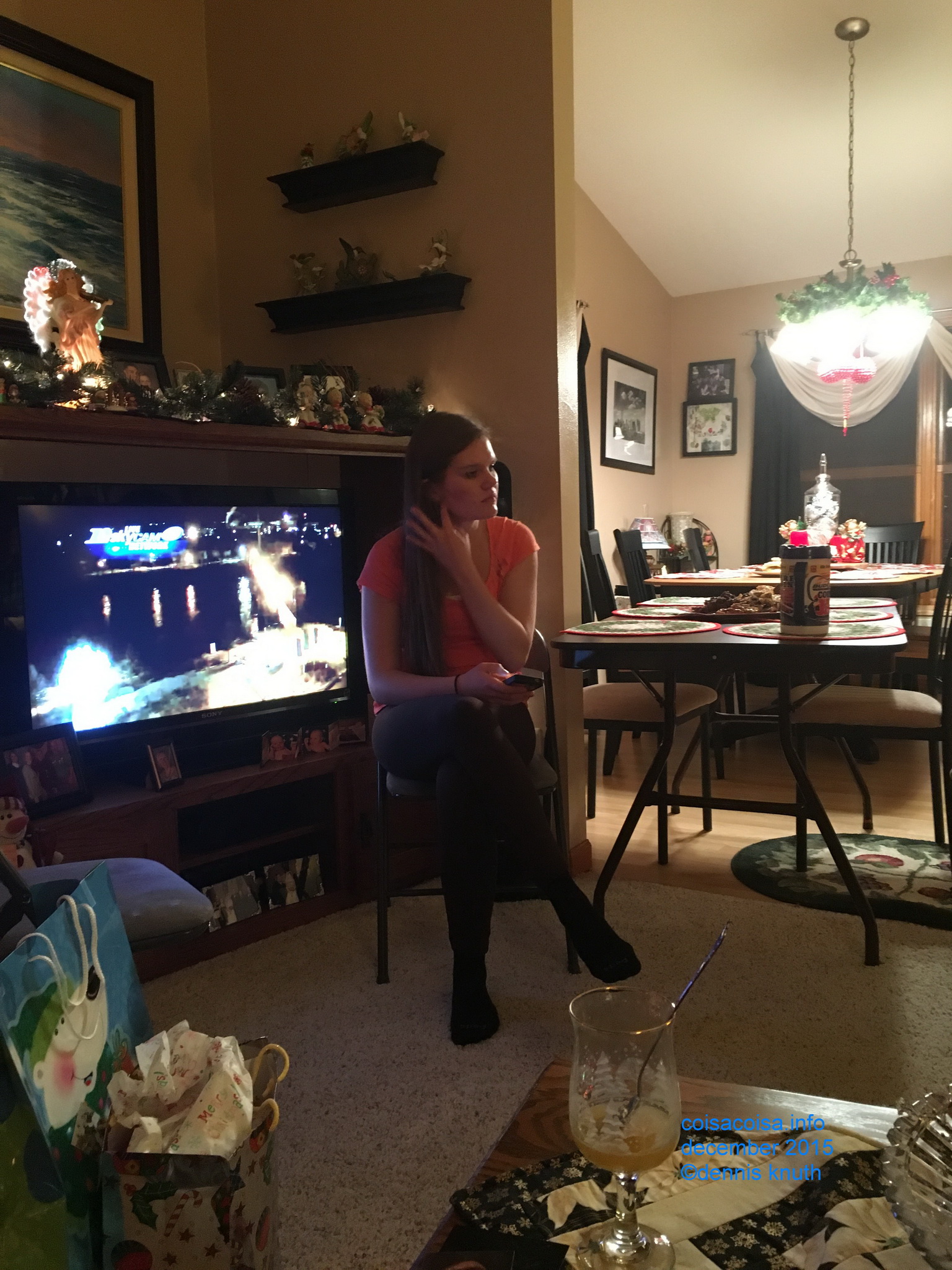 Beautiful Kelsey smooths her hair at Christmas