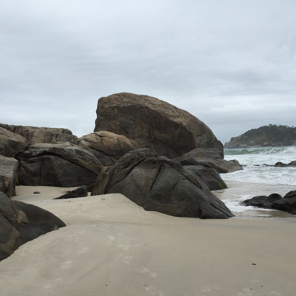 Rocks take the waves on the beach