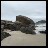 Rocks take the waves on the beach