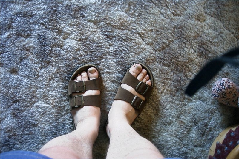 Man's Feet in Sandles on Blue Sandal