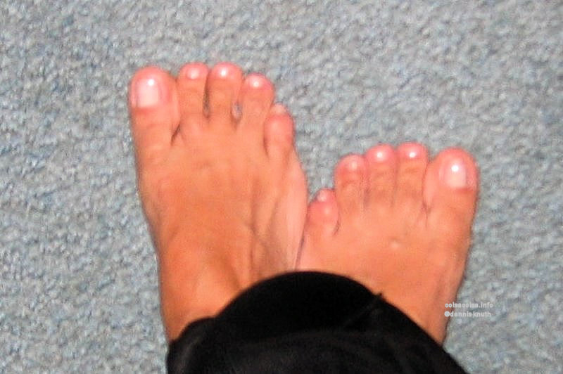 Upstanding woom's feet on a blue carpet 